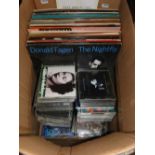 A box of LP records and CDs.