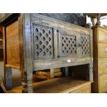 An Antique Indian marriage chest with a pierced panelled single door front on shaped legs.