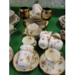 Edwardian Atlas china tea service with floral decoration and a pair of gilded and enamelled goblets.