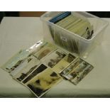 A box of various loose postcards.