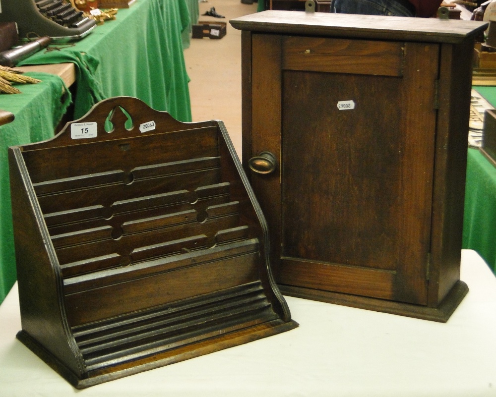 An oak table top stationery rack and a small cabinet.