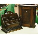 An oak table top stationery rack and a small cabinet.