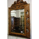 A French carved and pierced framed bevelled edge wall mirror.