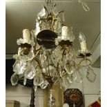 A gilt metal chandelier with lustre drops.