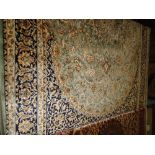 A green ground Keshan carpet, 2.3M x 1.6M.