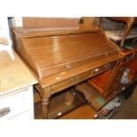 A mahogany lady's writing desk with tambour front, 2 frieze drawers on fluted legs.