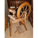 A stained beech spinning wheel.