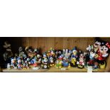A shelf of Disney Mickey Mouse figures.