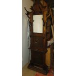 A French carved and panelled oak mirror back hall stand.