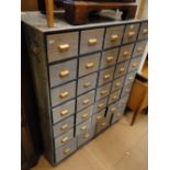 A grey and floral painted bank of 34 drawers.