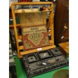 A 19th century Anglo-Indian carved ebony desk stand, length 33cm and a Persian weaving loom, (2).