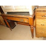 An Edwardian oak writing desk with single drawer on turned legs.