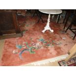 A large peach ground Chinese design rug, 12' x 9'.