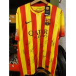 A Barcelona Football Club tee shirt signed by the starting 11.