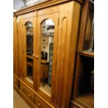 A modern pine 2-mirror door wardrobe with drawer fitted base.