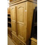 A modern pine 2-door wardrobe with drawer fitted base.