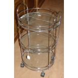 A chrome circular 3-tier trolley with glass shelves.