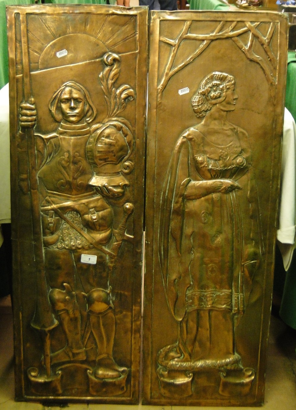 WITHDRAWN A pair of Keswick School of Industrial Art embossed copper panels depicting a knight and