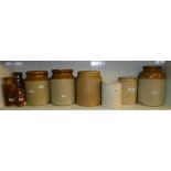 A shelf of Stoneware storage jars and bottles.