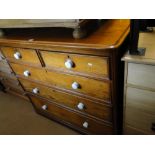 A Victorian pitch pine 5-drawer chest with ceramic handles.