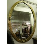 An oval brass framed wall mirror.