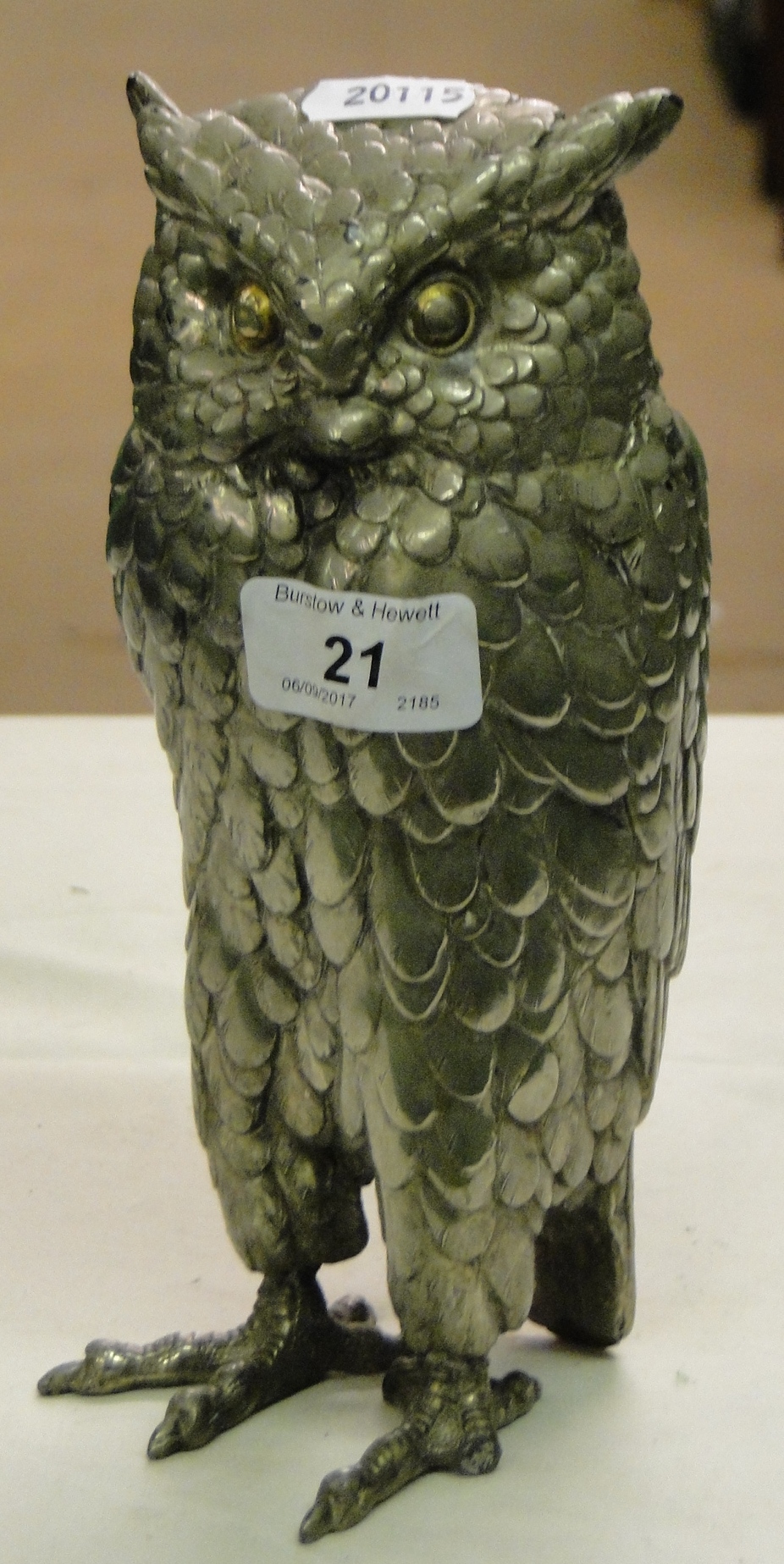 Polished metal owl figure.