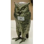 Polished metal owl figure.