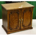 An oak table top cabinet with shelved interior.