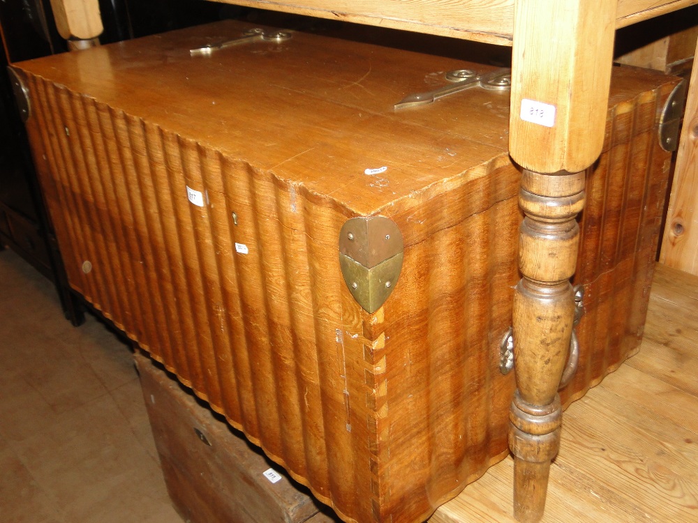 A large shaped teak blanket chest with brass hinges and carrying handles, length 3'3".