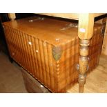 A large shaped teak blanket chest with brass hinges and carrying handles, length 3'3".