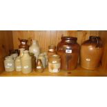 A shelf of Stoneware jars and a flagon.