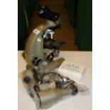 A student's microscope by Vickers Instruments with accessories and slides.
