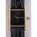 A lady's Cartier silver gilt mechanical wristwatch, black dial with Cartier strap, case width 20mm,