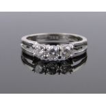 An 18ct white gold 3 stone diamond ring, size L.