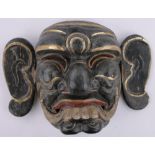An Oriental carved and gilded wood mask, height 30cm.