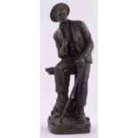 A reproduction bronze figure of a man resting at a gate, unsigned, height 54cm.