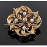 An unmarked high carat gold diamond and pearl set acanthus leaf design brooch, 26mm across, 7.3g.