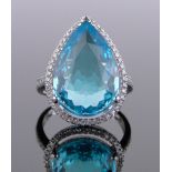 A 14ct white gold 10ct pear-cut topaz ring, surrounded by a row of diamonds, approx. 0.