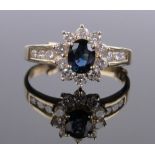 A 14ct gold sapphire and diamond cluster ring, diamond set shoulders, size R.