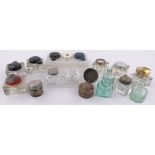 A collection of Victorian and later glass inkwells.