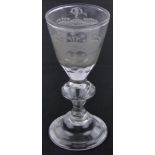 An 18th century wine glass, with wheel engraved armorial crest and folded foot, height 17cm,