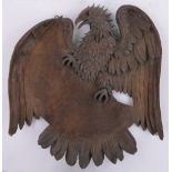 A 19th century carved and stained beech Heraldic eagle design hanging wall ornament,