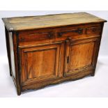 An 18th century French chestnut dresser base, 3 frieze drawers and fielded panelled cupboards under,