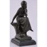 A reproduction bronze seated girl, on black marble plinth, height 38cm.