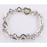 A Tiffany silver and gold heart link bracelet, 37.6g.