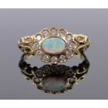 An 18ct gold opal and diamond cluster ring, setting height 10mm, size N.