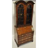 An 18th century walnut double domed top bureau bookcase, bevelled glass panelled doors above,