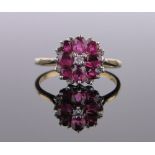 An 18ct gold ruby and diamond cluster ring, circa 1970, setting height 12mm, size R.