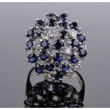 A large 18ct white gold sapphire and diamond bombe cluster ring, 1973, setting height 20mm, size M.