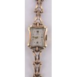 A lady's 9ct gold Tudor Royal cocktail wristwatch, 9ct articulated strap, case width 16mm, boxed.